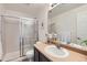Well-lit bathroom featuring a glass shower and vanity with sink at 2541 S Bahama Cir # F, Aurora, CO 80013