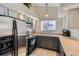 Bright kitchen with stainless steel appliances, tile floor, and neutral countertops at 2541 S Bahama Cir # F, Aurora, CO 80013