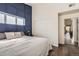 Stylish bedroom with blue accent wall, cozy bedding, and ample closet space at 2541 S Bahama Cir # F, Aurora, CO 80013
