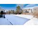 Spacious backyard covered in snow, ideal for outdoor recreation at 3564 S Jebel Cir, Aurora, CO 80013