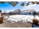 Spacious backyard with gravel and a partially snow-covered lawn at 3564 S Jebel Cir, Aurora, CO 80013