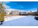 Spacious backyard covered in snow, ideal for outdoor recreation at 3564 S Jebel Cir, Aurora, CO 80013