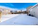 Spacious backyard covered in snow, ideal for outdoor recreation at 3564 S Jebel Cir, Aurora, CO 80013