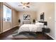 Primary bedroom with dark hardwood floors, window, and ceiling fan at 3564 S Jebel Cir, Aurora, CO 80013