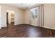 Bedroom with dark hardwood floors, window, and closet at 3564 S Jebel Cir, Aurora, CO 80013