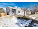 Gray house with a blue door and a partially snow-covered lawn at 3564 S Jebel Cir, Aurora, CO 80013