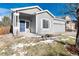 Gray house with a blue door and a partially snow-covered lawn at 3564 S Jebel Cir, Aurora, CO 80013