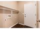 Functional laundry room with built-in shelving and vinyl flooring at 3564 S Jebel Cir, Aurora, CO 80013