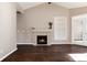 Living room with a fireplace and built-in shelves, hardwood floors at 3564 S Jebel Cir, Aurora, CO 80013