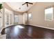 Spacious living room with high ceiling, hardwood floors, and French doors at 3564 S Jebel Cir, Aurora, CO 80013