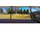 A view of a large, well-kept backyard, seen from the brick patio of the property at 3000 S Newland St, Denver, CO 80227