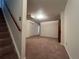 Basement recreation room featuring carpet flooring and access to stairs at 3000 S Newland St, Denver, CO 80227