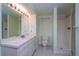 Bathroom with a single sink, light walls and tile floors at 3000 S Newland St, Denver, CO 80227