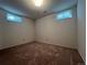 Finished basement bedroom with tan carpeting and windows at 3000 S Newland St, Denver, CO 80227