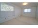 A well-lit bedroom featuring neutral paint and carpet with two bright windows at 3000 S Newland St, Denver, CO 80227