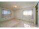 Spacious bedroom featuring two windows, neutral paint, carpet, and built in closet at 3000 S Newland St, Denver, CO 80227