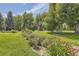 Beautiful community park featuring manicured lawns, blooming flowers, benches, and walking paths at 3000 S Newland St, Denver, CO 80227
