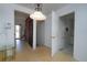 Inviting foyer with a brick accent wall, staircase, and open doorway to the kitchen at 3000 S Newland St, Denver, CO 80227