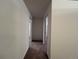 Hallway with carpeting and entry ways to other rooms in the house at 3000 S Newland St, Denver, CO 80227