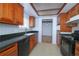 Traditional kitchen featuring wooden cabinetry and black appliances at 3000 S Newland St, Denver, CO 80227