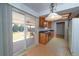 Bright kitchen with cherry cabinets, black countertops, and sliding door to patio at 3000 S Newland St, Denver, CO 80227