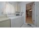 A view of the laundry room complete with appliances and cabinet space for storage at 3000 S Newland St, Denver, CO 80227