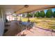 Covered brick patio featuring outdoor seating and a view of the spacious backyard at 3000 S Newland St, Denver, CO 80227