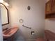 Charming half bathroom featuring a pedestal sink, toilet, and coordinated fixtures at 3000 S Newland St, Denver, CO 80227