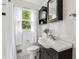 Updated bathroom with classic subway tile, dark vanity, and ample natural light, offers a modern feel at 4912 Indiana St, Golden, CO 80403