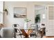 Bright dining area with a glass table, seating for six, and a view to a comfy side room at 4912 Indiana St, Golden, CO 80403