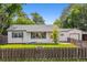 Charming single-story home featuring a well-manicured lawn and a classic picket fence at 4912 Indiana St, Golden, CO 80403