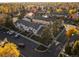 Aerial view of townhomes with parking, street and mature trees at 1273 S Zeno Way # A, Aurora, CO 80017