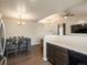 A dining area with dark wooden furniture and modern lighting fixtures is attached to the kitchen at 1273 S Zeno Way # A, Aurora, CO 80017