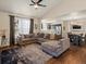 Inviting living room featuring a large sectional sofa, ceiling fan, and hardwood floors at 1273 S Zeno Way # A, Aurora, CO 80017