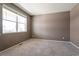 Neutral bedroom with large window allows natural light to fill the space, creating a warm atmosphere at 6472 N Dunkirk Ct, Aurora, CO 80019