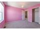 Vibrant pink bedroom with a light fixture and a window allowing light to fill the room, creating a happy space at 6472 N Dunkirk Ct, Aurora, CO 80019