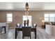 Chic dining area adjacent to the kitchen, featuring stylish light fixture and an inviting atmosphere for meals and gatherings at 6472 N Dunkirk Ct, Aurora, CO 80019