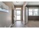 Welcoming entryway with light wood floors, offering a view of the neighborhood and access to other rooms at 6472 N Dunkirk Ct, Aurora, CO 80019