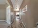 Inviting hallway with light wood floors leading to the dining area, creating a seamless transition throughout the home at 6472 N Dunkirk Ct, Aurora, CO 80019