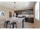 The kitchen featuring stainless steel appliances, a central island with bar seating, and plenty of cabinet space at 6472 N Dunkirk Ct, Aurora, CO 80019