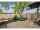 Fenced backyard featuring a large tree, greenery, a bench and a small bistro set at 1254 S Yosemite Way # 99, Denver, CO 80247