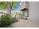 View of fenced backyard featuring a large tree, greenery and a bench along the exterior at 1254 S Yosemite Way # 99, Denver, CO 80247