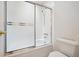 Bathroom featuring shower and bathtub combination with white tiled walls and a frosted glass sliding shower door at 1254 S Yosemite Way # 99, Denver, CO 80247