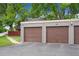 View of the garage featuring two brown garage doors at 1254 S Yosemite Way # 99, Denver, CO 80247