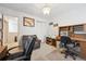 Home office with built-in desk, bookcases and a chair at 1254 S Yosemite Way # 99, Denver, CO 80247