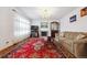 Cozy living room with fireplace, chandelier, and a large patterned rug at 1254 S Yosemite Way # 99, Denver, CO 80247