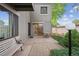 Private outdoor patio featuring a sitting bench, dining table, and sliding glass doors leading inside at 1254 S Yosemite Way # 99, Denver, CO 80247