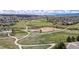 Aerial view showcasing a green park, walking paths, and nearby residential areas, perfect for outdoor activities at 1041 Riddlewood Rd, Highlands Ranch, CO 80129