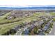 Aerial view capturing a neighborhood with well-maintained homes, lush greenery, and rolling hills in the background at 1041 Riddlewood Rd, Highlands Ranch, CO 80129