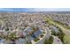Aerial view of a residential neighborhood highlighting tree-lined streets and a mix of single-Gathering homes at 1041 Riddlewood Rd, Highlands Ranch, CO 80129